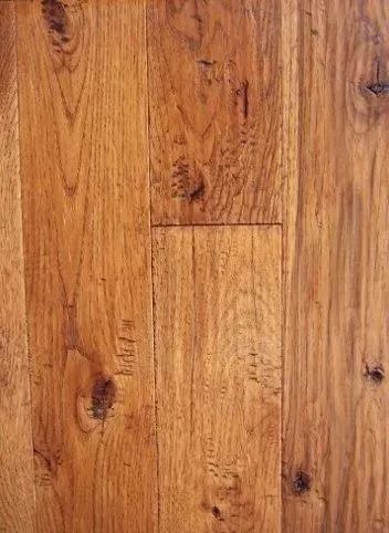 Close-up of a warm brown wooden plank floor with visible grain and knots