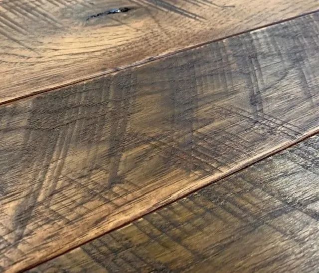 Close-up of weathered wooden planks with diagonal grain and gray-brown tones