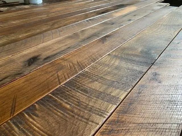 Close-up of rustic wooden floorboards with warm brown tones and visible grain patterns