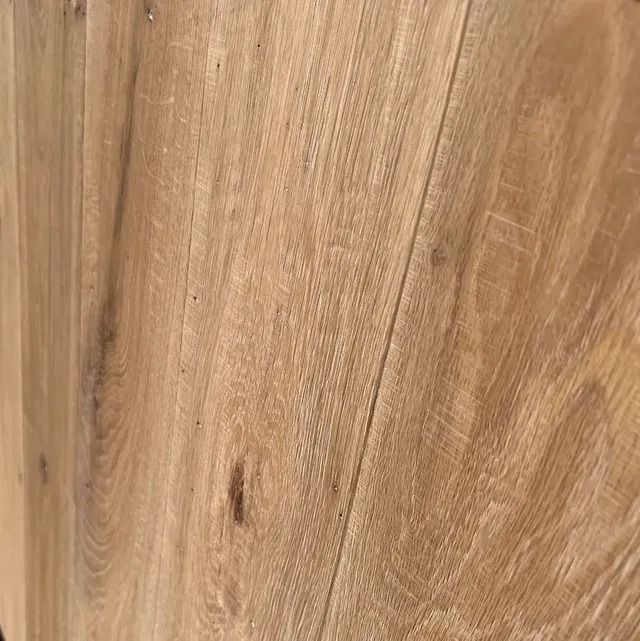 Close-up of light brown wood grain with knots and curved patterns