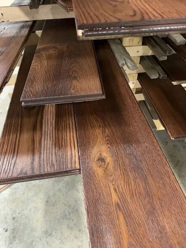 Stacked dark wood flooring planks in a store display.