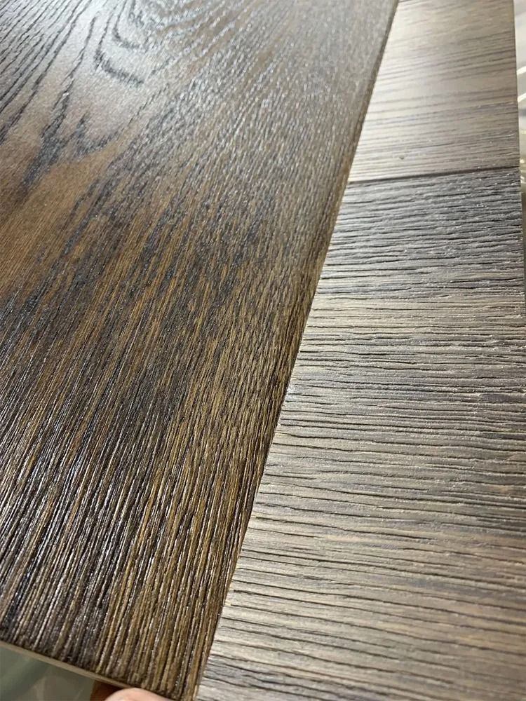 Close-up of two wood flooring samples with contrasting dark and light grain patterns.