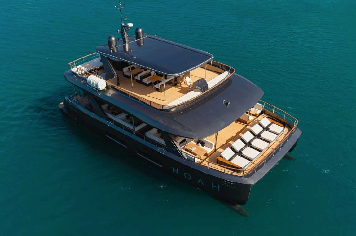 Luxury yacht cruising on clear blue water, viewed from above