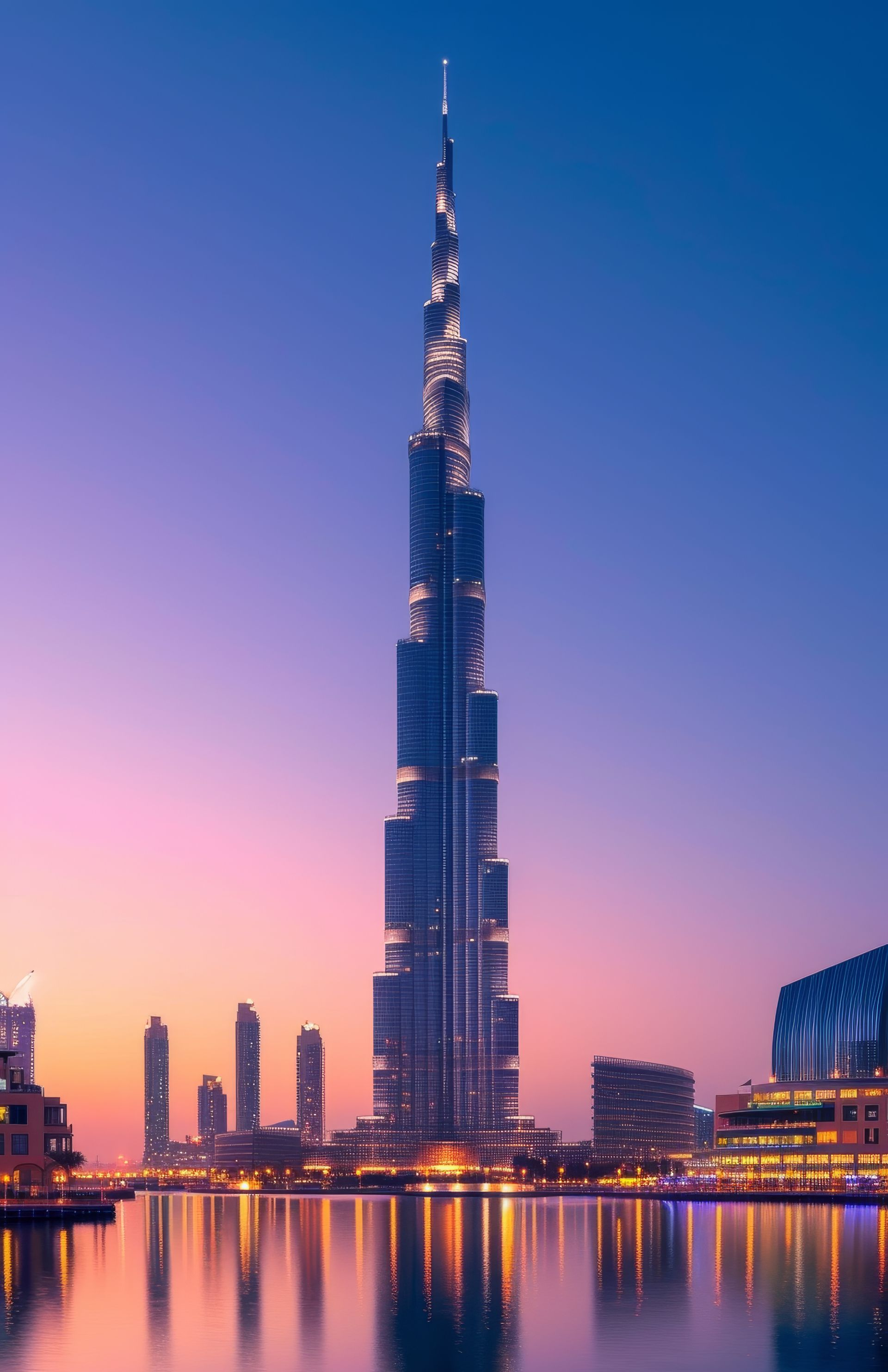 Dubai skyline at sunset with the Burj Khalifa reflecting on calm water