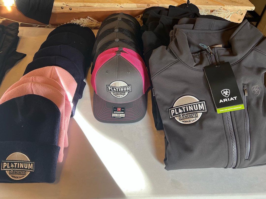 Table with beanies, caps, and jacket with 