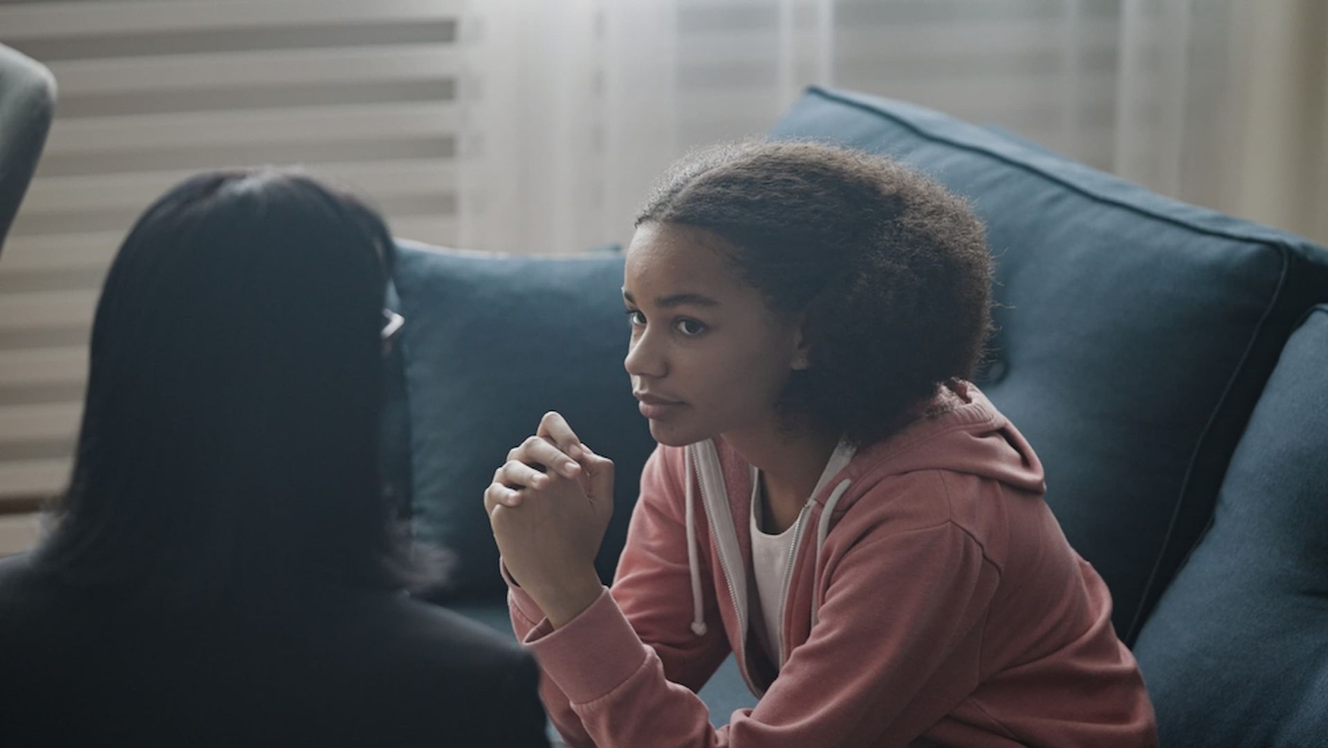 A Young Girl Is Sitting on A Couch Talking to A Woman — Psych Solutions NT in Leanyer, NT