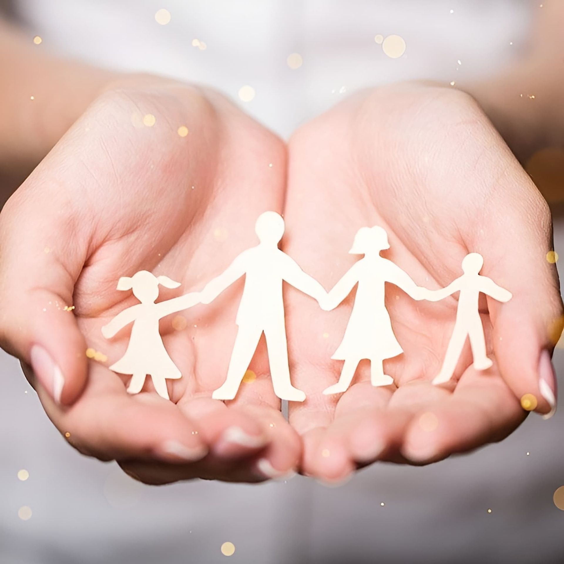 A Person Is Holding a Paper Cut out Of a Family Holding Hands — Psych Solutions NT in Leanyer, NT