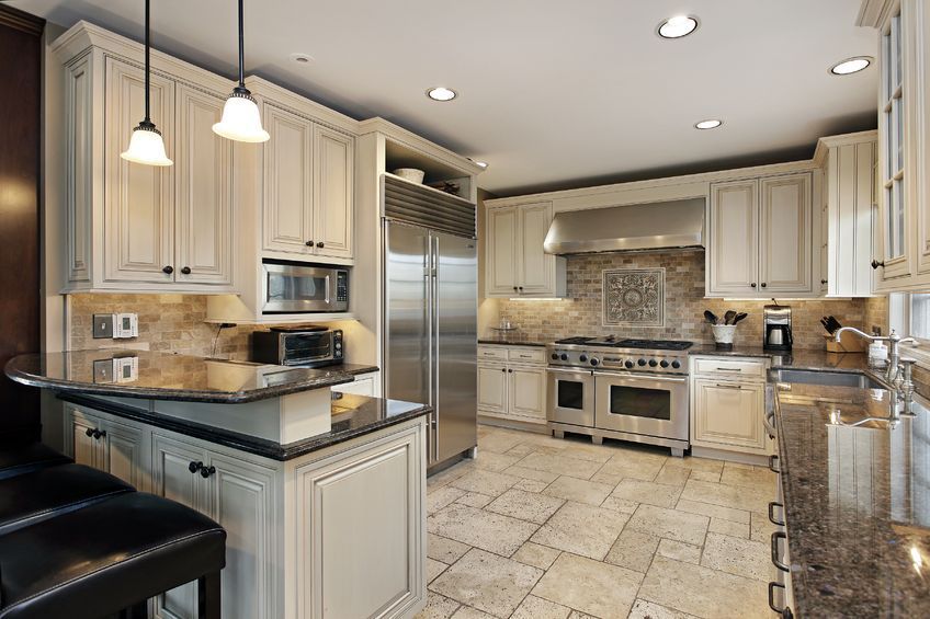 Elegant kitchen with cream cabinets, stainless steel appliances, and granite countertops.