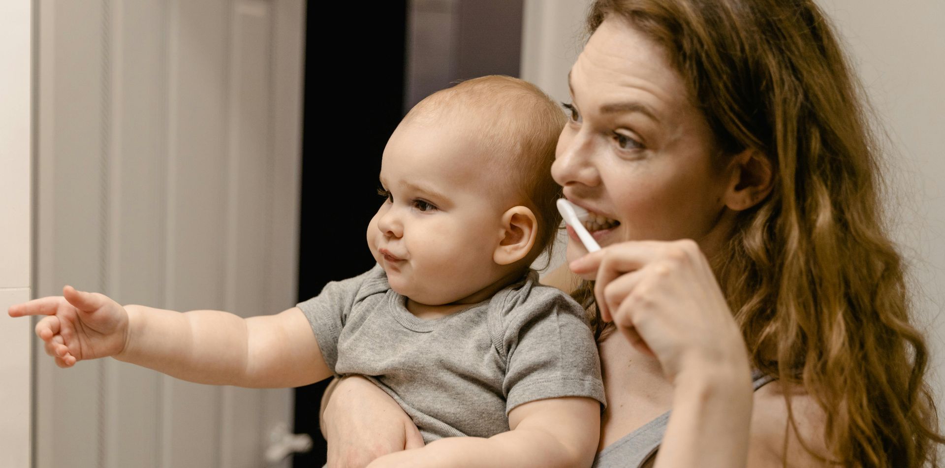 Baby watching Mom brush teeth