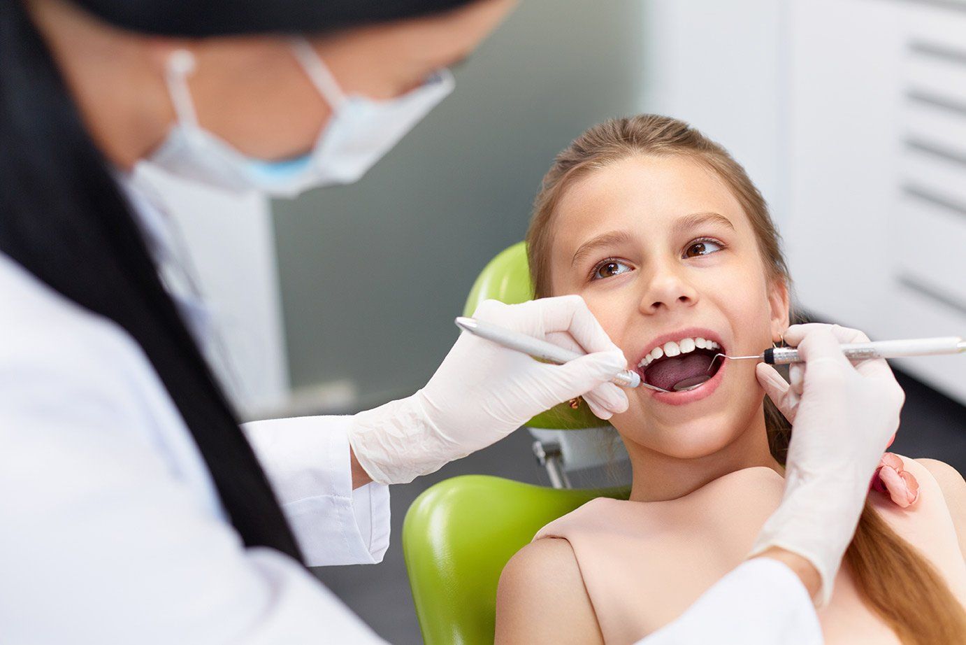 Young girl getting her teeth cleaned