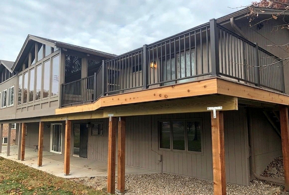 Empty glass shower enclosure with white subway tile walls and pebble floor