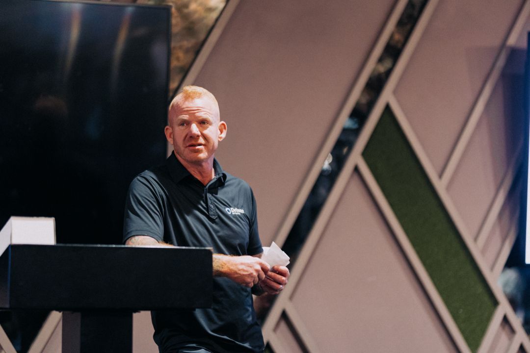 A man is standing at a podium giving a presentation.