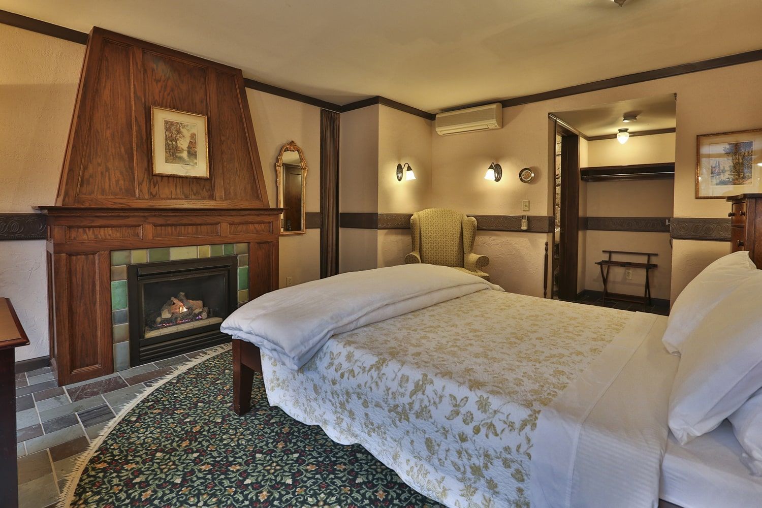 A hotel room with a fireplace and a bed