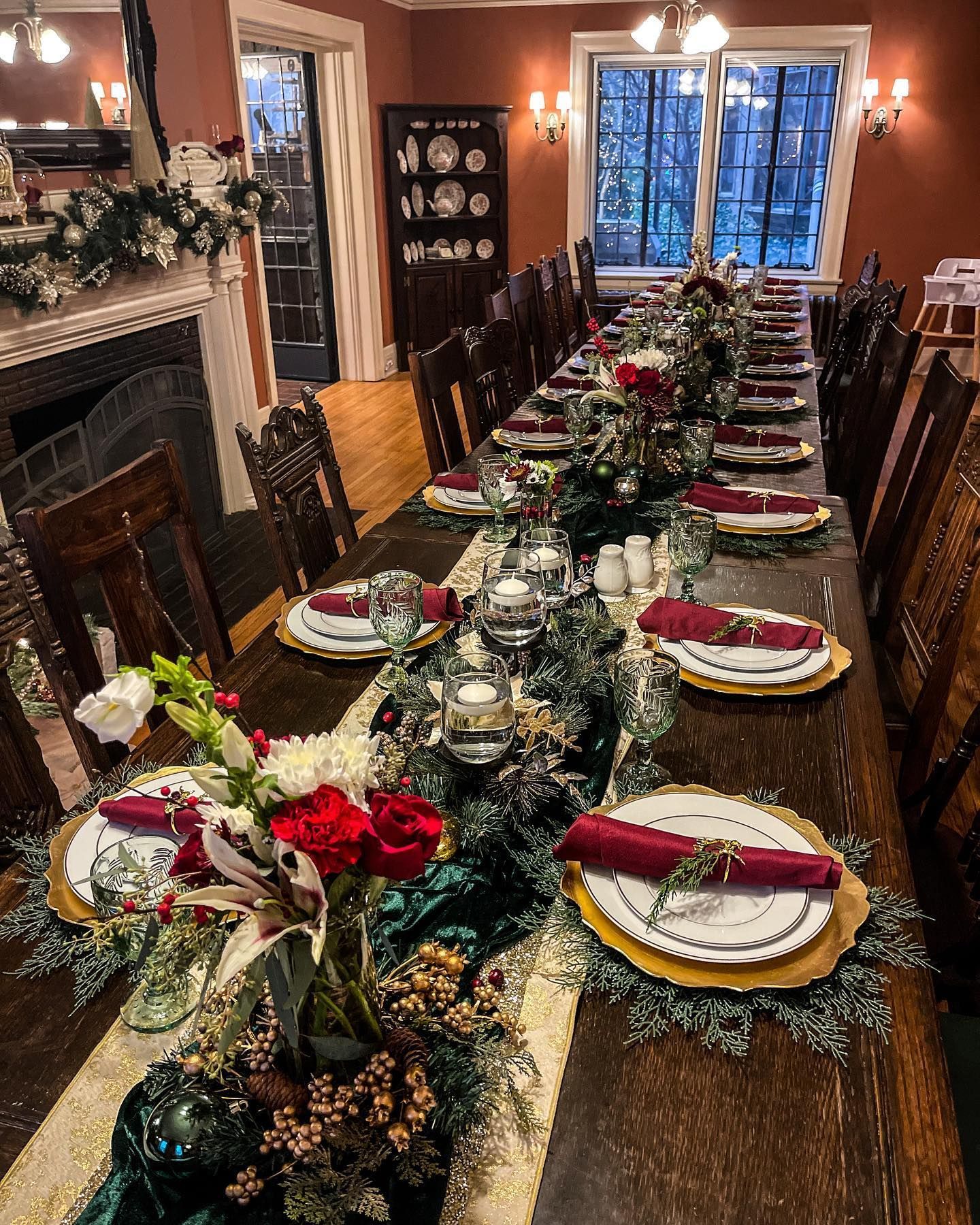 A long wooden table is set for a christmas dinner party.