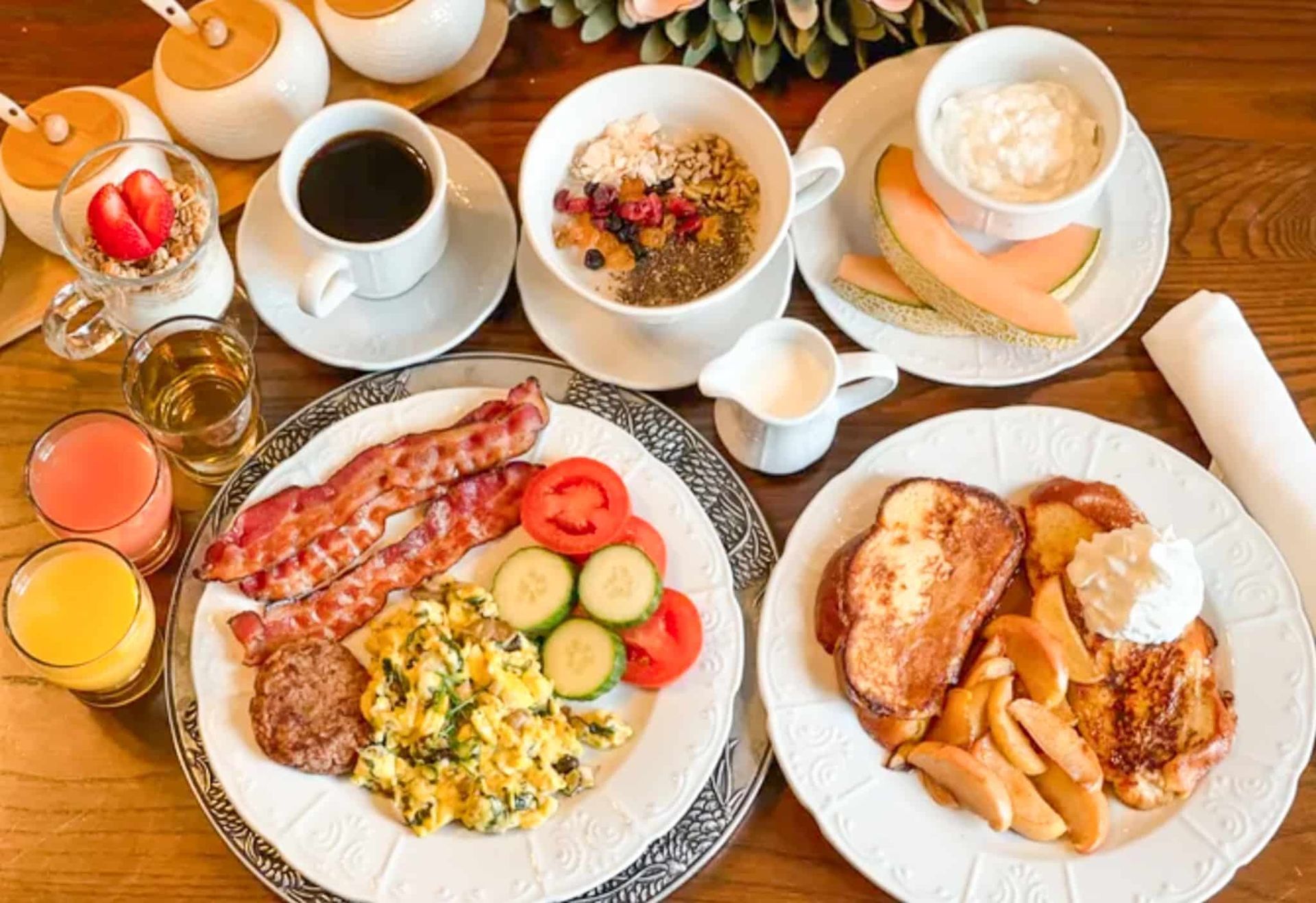 A table topped with plates of food and drinks.