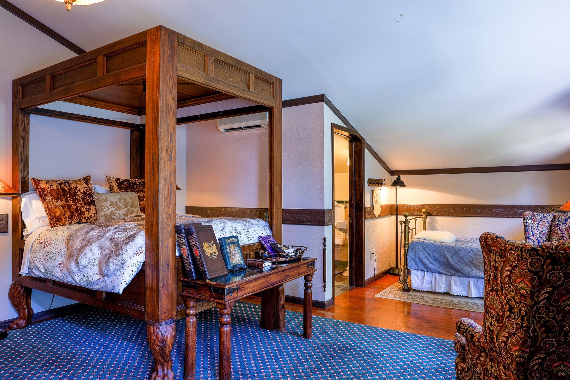 There is a four poster bed in the middle of the room.