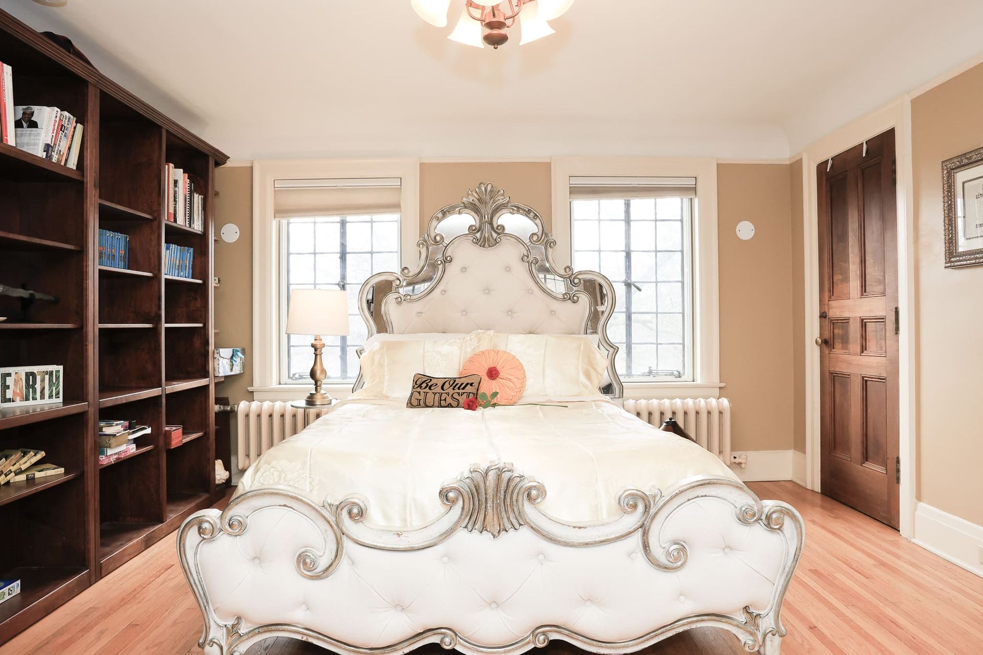 A bedroom with a large bed and lots of bookshelves