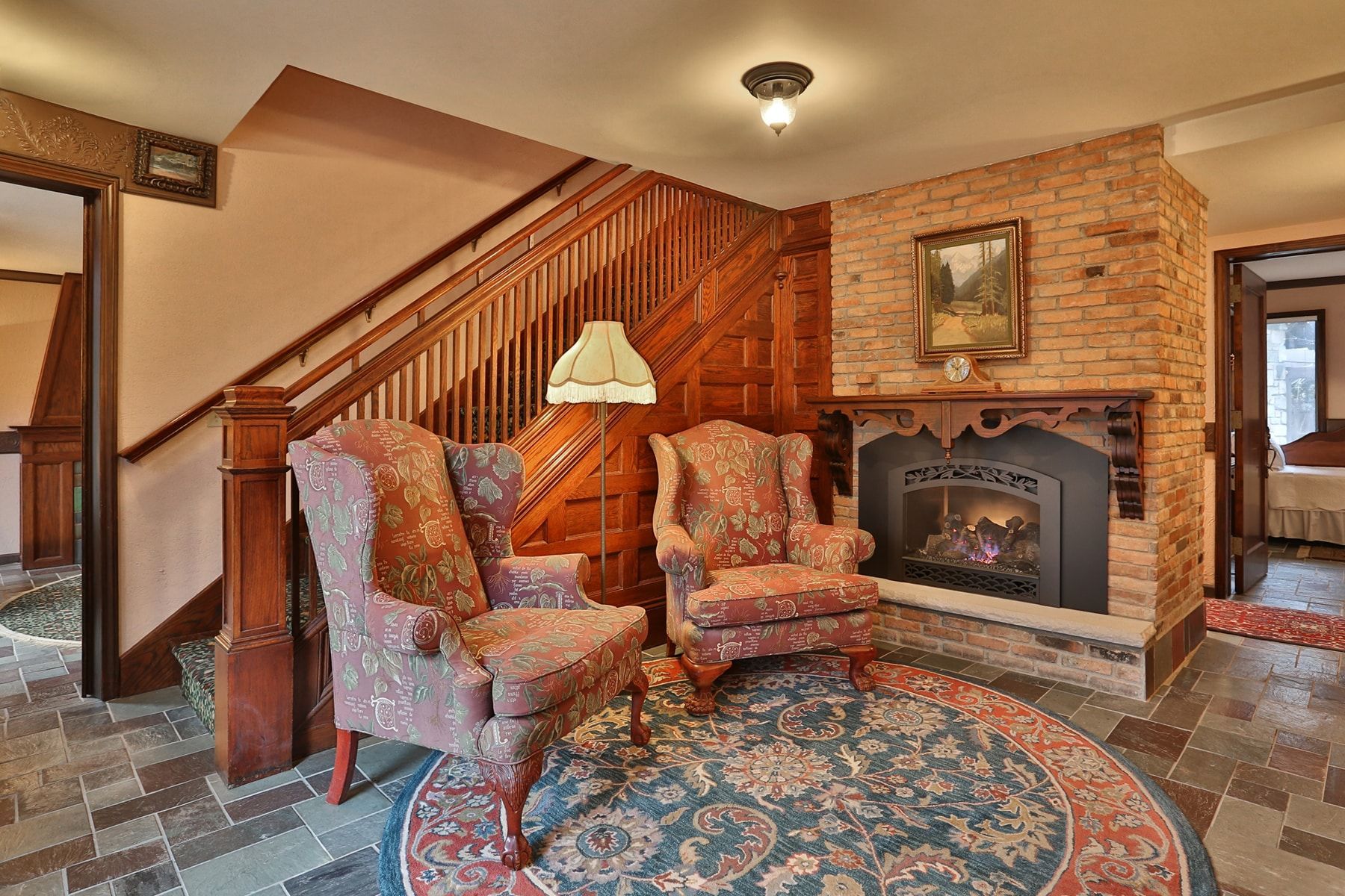 A living room with two chairs and a fireplace.