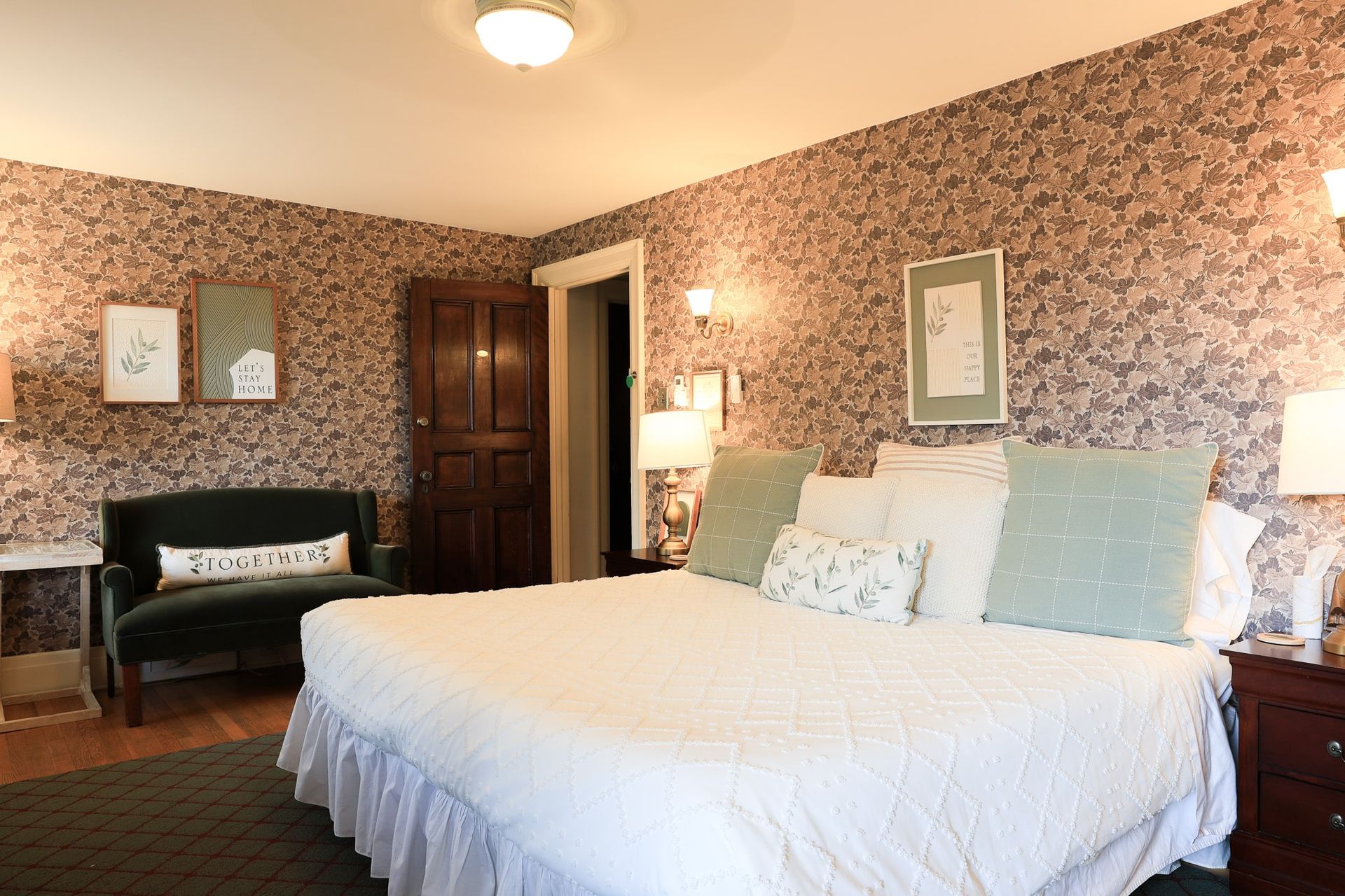 A bedroom with a large bed and a couch.