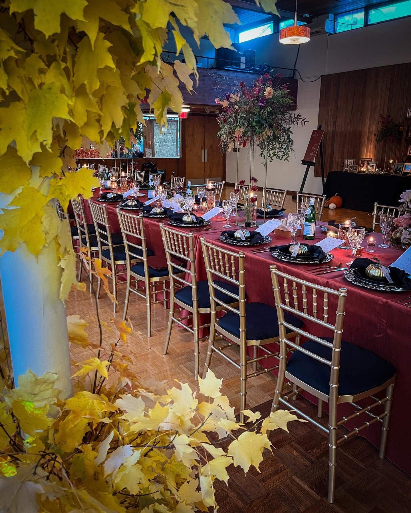 A long table and chairs are set for a wedding reception.