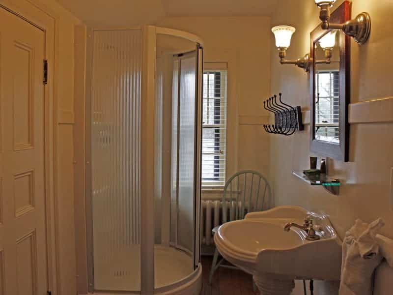 A bathroom with a sink and a shower stall