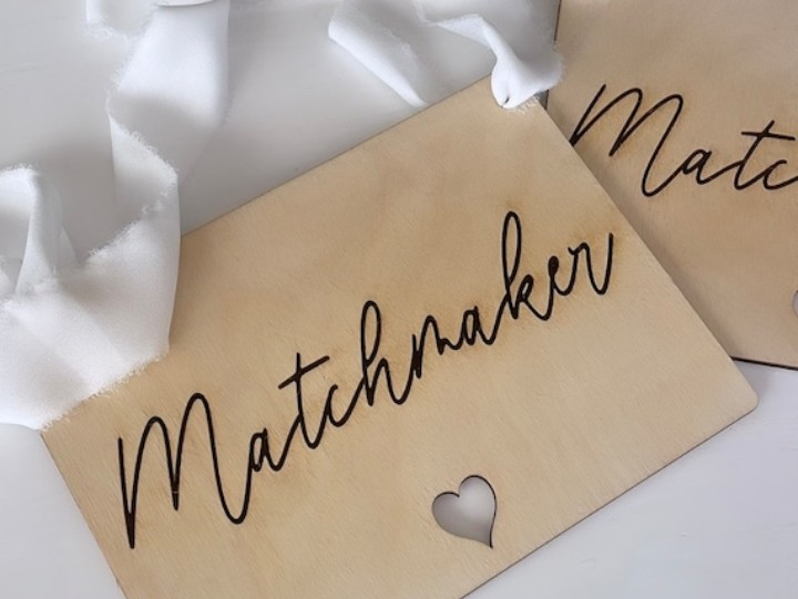 Tan cards labeled “Matchmaker” with a small heart cutout on white fabric