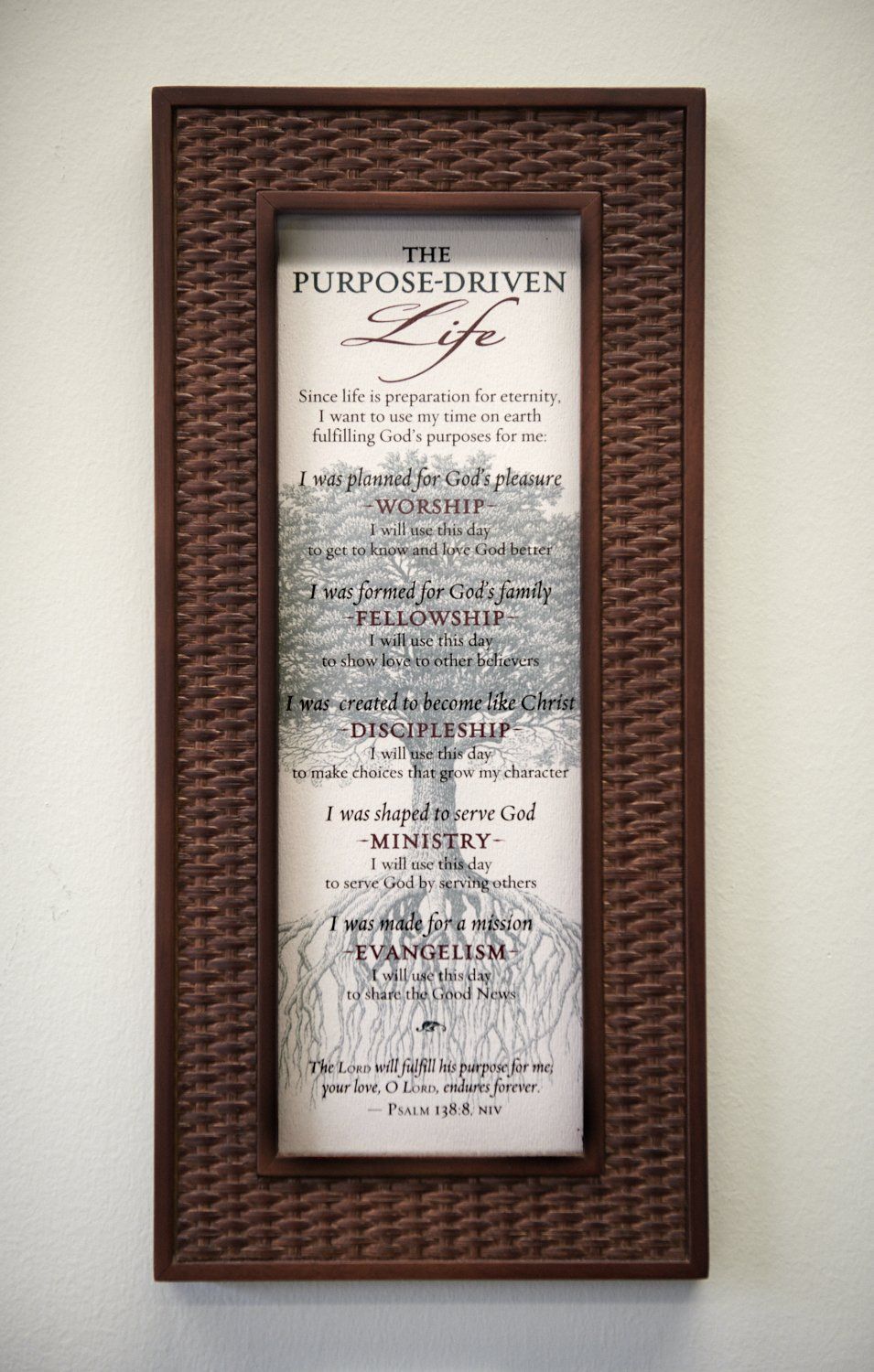 Framed wall sign with a woven brown border and a white “The Lord’s Prayer” print