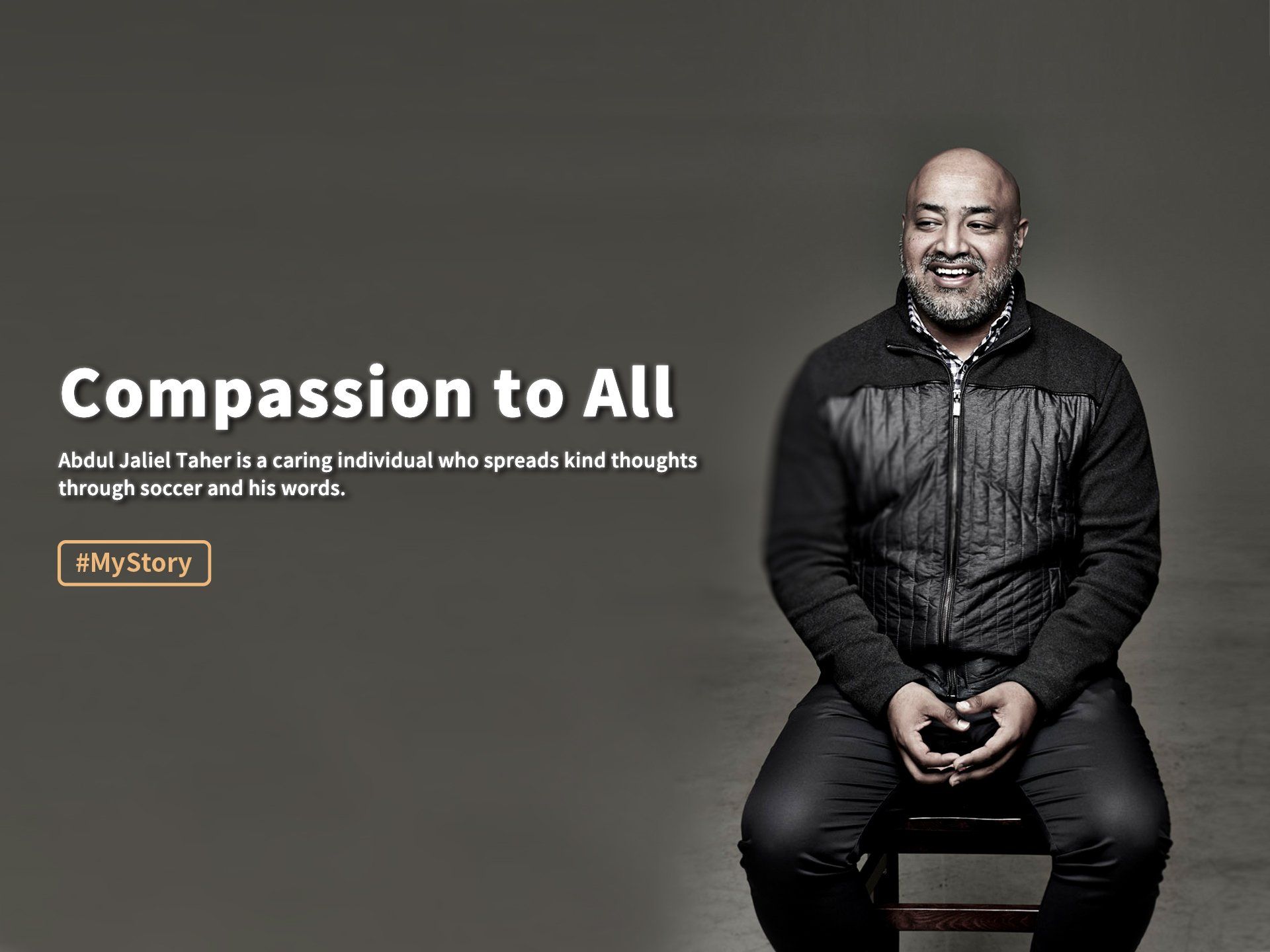 Smiling man seated against dark gray background beside text reading “Compassion to All”