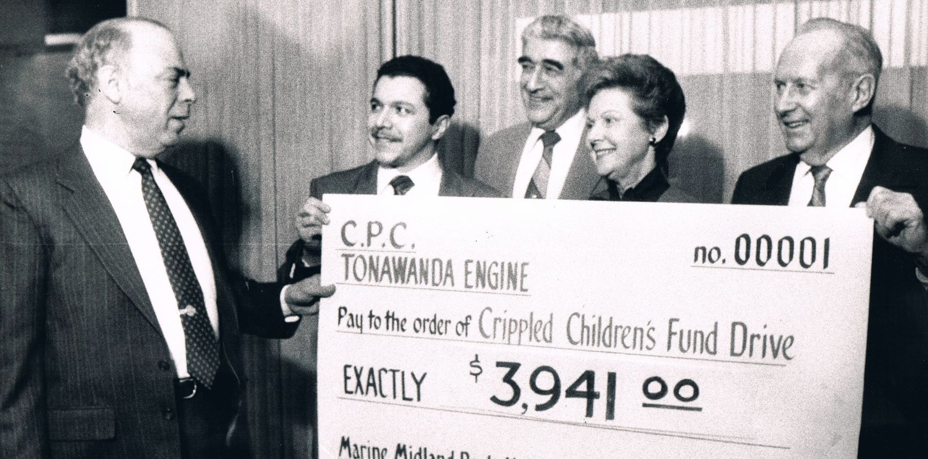 Four men present a giant check for 3,941 to C.P.C. Tornadico Engine.