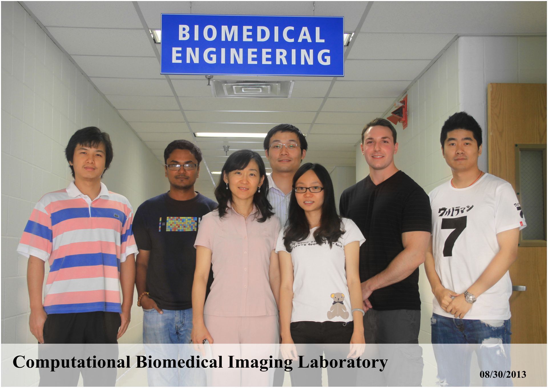 Group portrait in a hallway under a “Biomedical Engineering” sign, with “Computational Biomedical Imaging Laboratory” text.