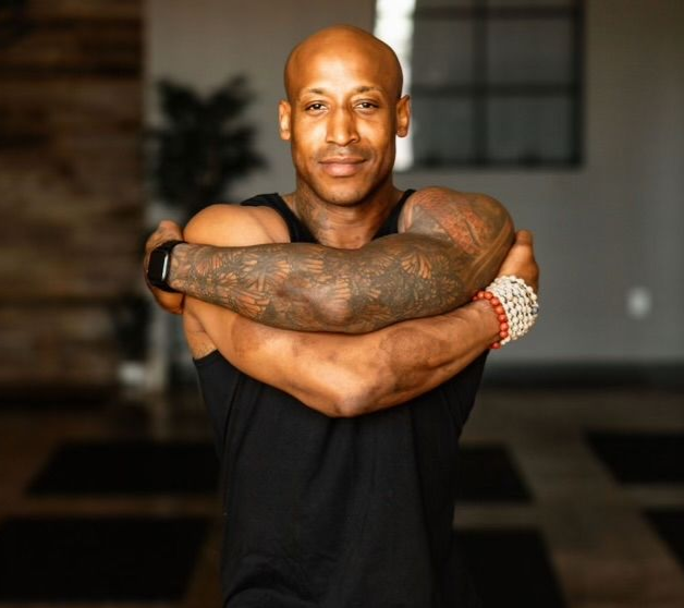 Portrait of Chris Jackson, an experienced vinyasa and hatha yoga instructor teaching at Uptown Yoga.