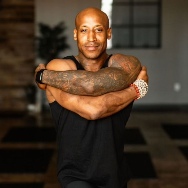 Portrait of Chris Jackson, an experienced vinyasa and hatha yoga instructor teaching at Uptown Yoga.
