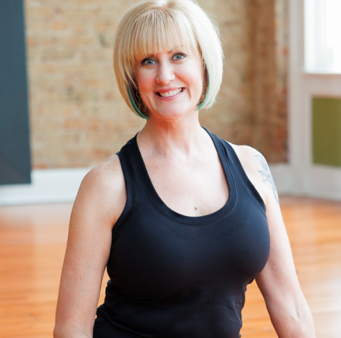 Diana Tennant, an E-RYT 500 certified yoga instructor with over 20 years of experience, specializing in Vinyasa and Ashtanga.