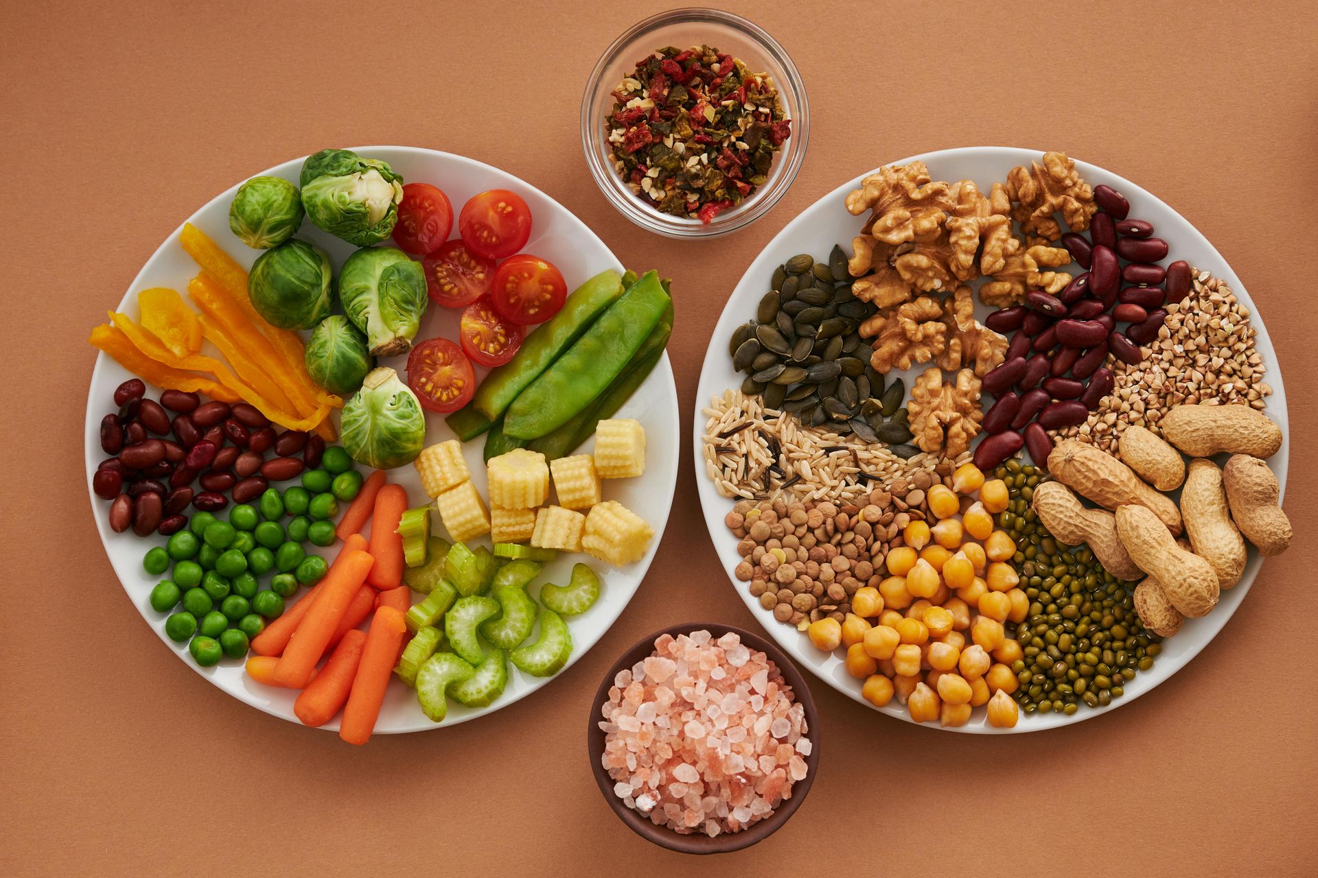 Plates of healthy pre-yoga foods like vegetables, nuts, and legumes for energy and comfort at Uptown Yoga in Dallas.