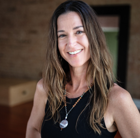 Jennifer Chitwood, owner and 500-hour certified instructor at Uptown Yoga, dedicated to building a welcoming yoga community.