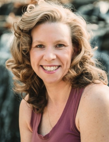 Portrait of Andrea Pfannstiel, a certified Baptiste yoga teacher at Uptown Yoga specializing in stress relief for corporate professionals.