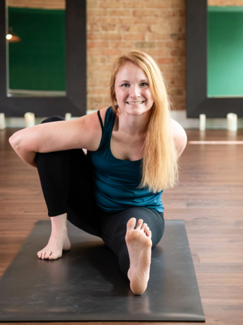 Uptown Yoga instructor Cat Breyfogle in a seated spinal twist, focusing on restorative movement for autoimmune support and chronic pain relief.