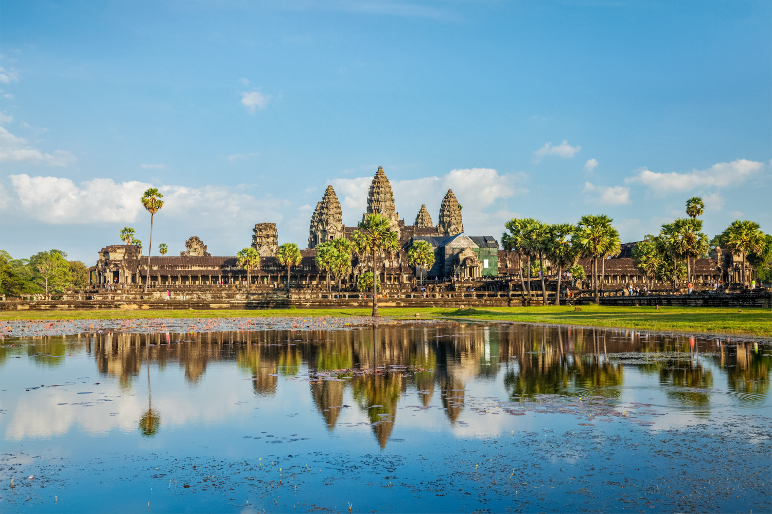 The ancient Angkor Wat temple reflecting in water during Uptown Yoga's purposeful travel and cultural wellness retreat in Siem Reap, Cambodia.