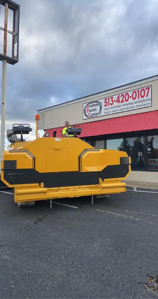 A Yellow Vehicle Is Parked In Front Of A Building | Middletown, OH | Affordable Paving Company