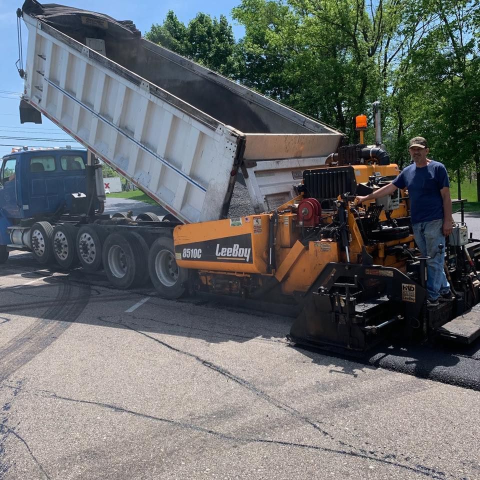 A Man Is Standing In Front Of A Truck | Middletown, OH | Affordable Paving Company