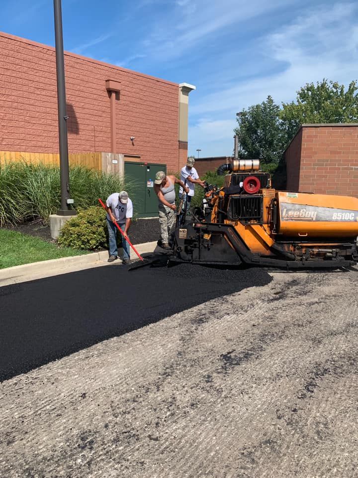 A Group Of People Are Working On A Driveway | Middletown, OH | Affordable Paving Company