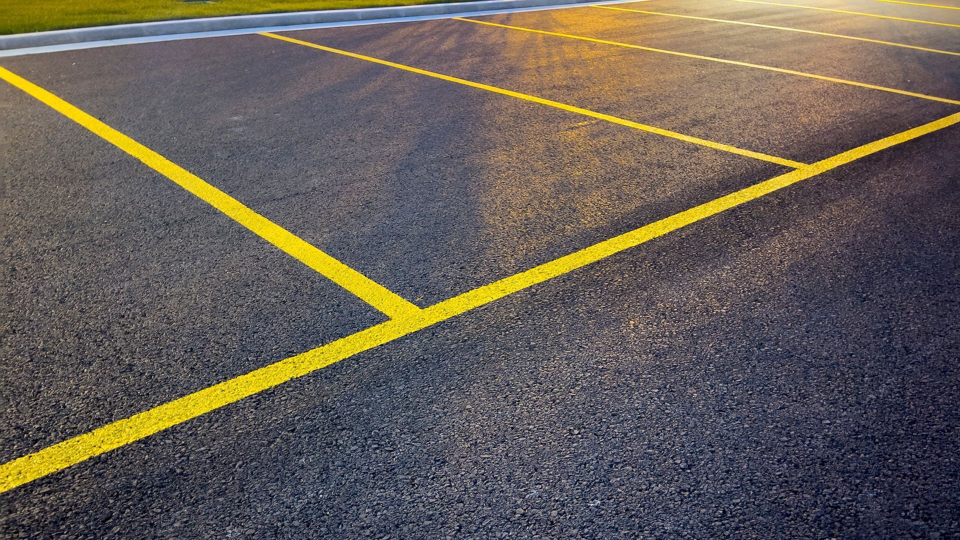 Yellow parking lines on dark asphalt.