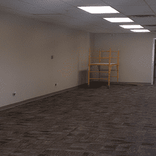 An empty room with a scaffolding in the corner