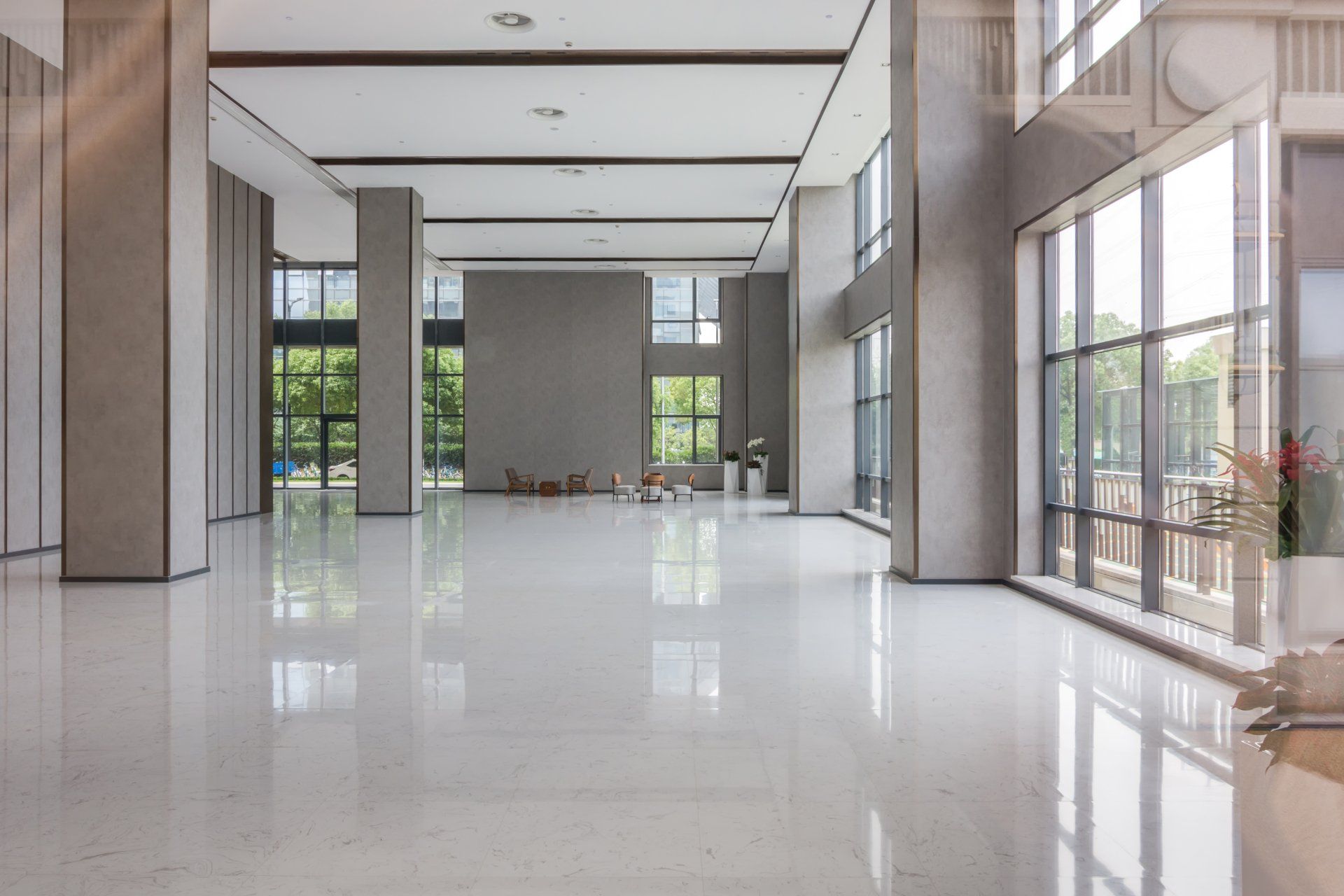 A large empty room with a lot of windows and columns.