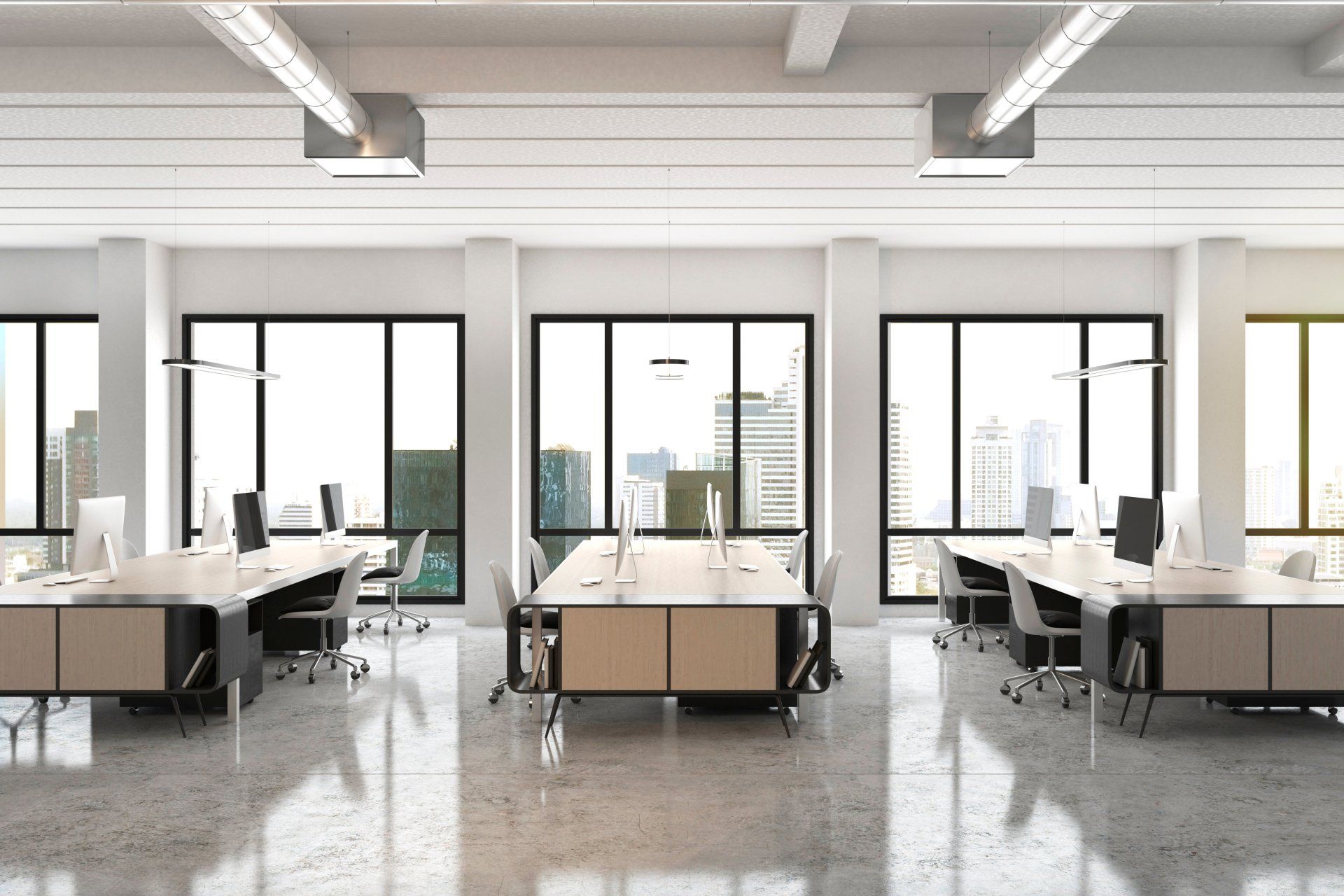 An empty office with a lot of windows and tables and chairs.
