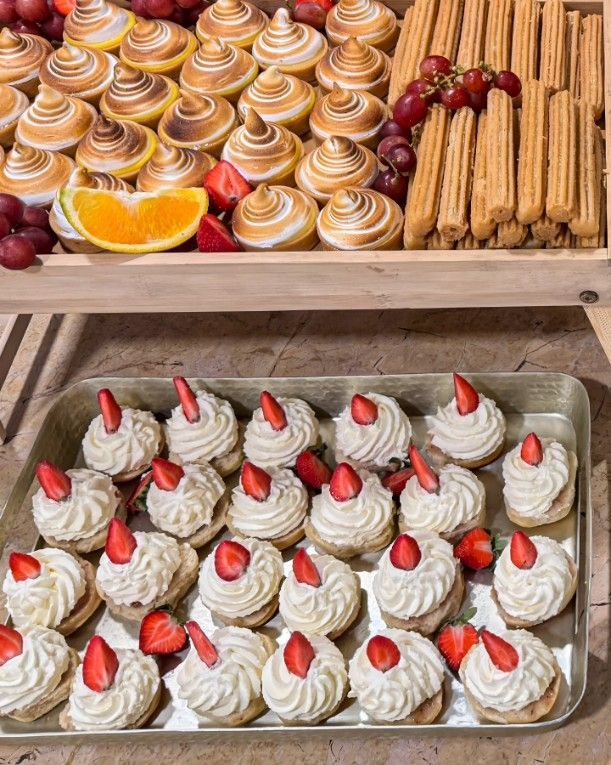 A Tray of Cupcakes With Whipped Cream and Strawberries on Top — Darwin Catering Company in Brinkin, NT