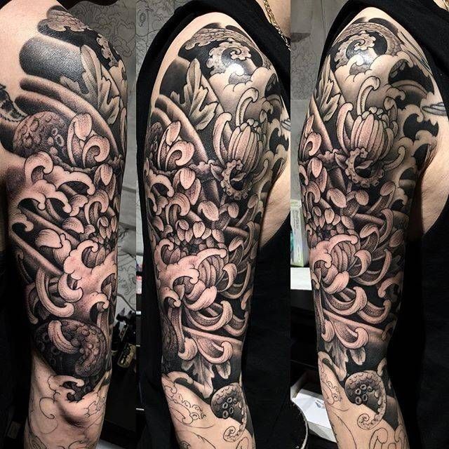 A black and white tattoo on a man 's arm