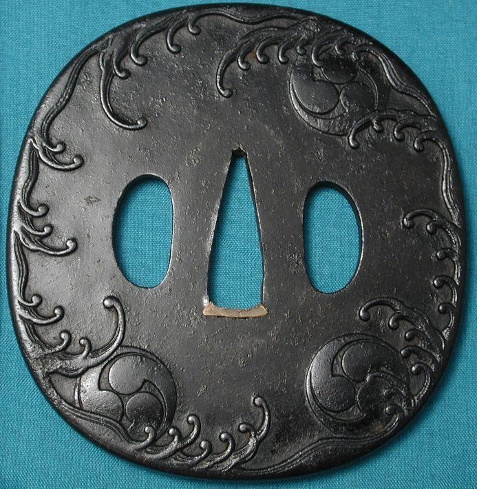 A black circle with a hole in the middle on a blue cloth
