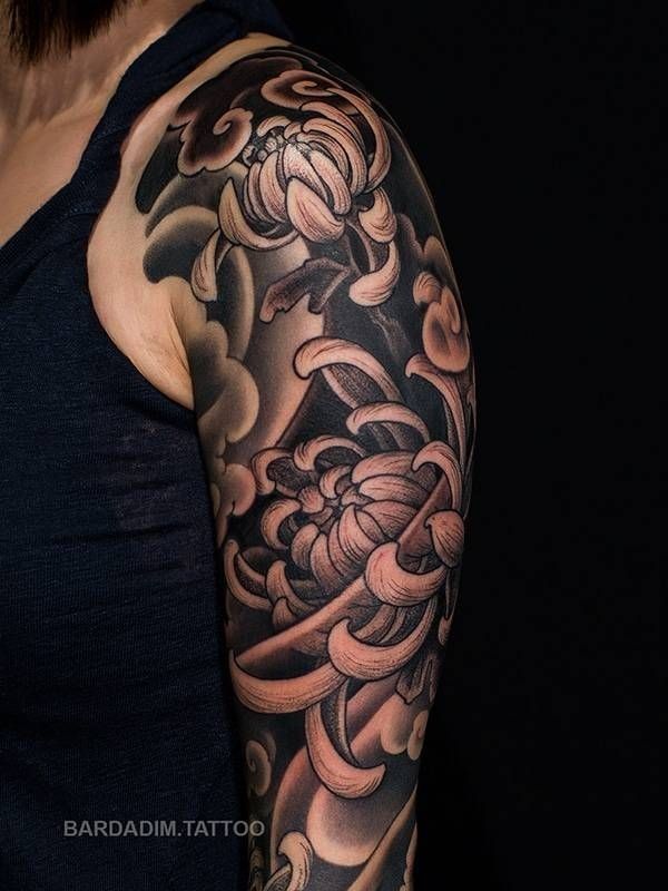 A man has a tattoo of a flower on his arm.