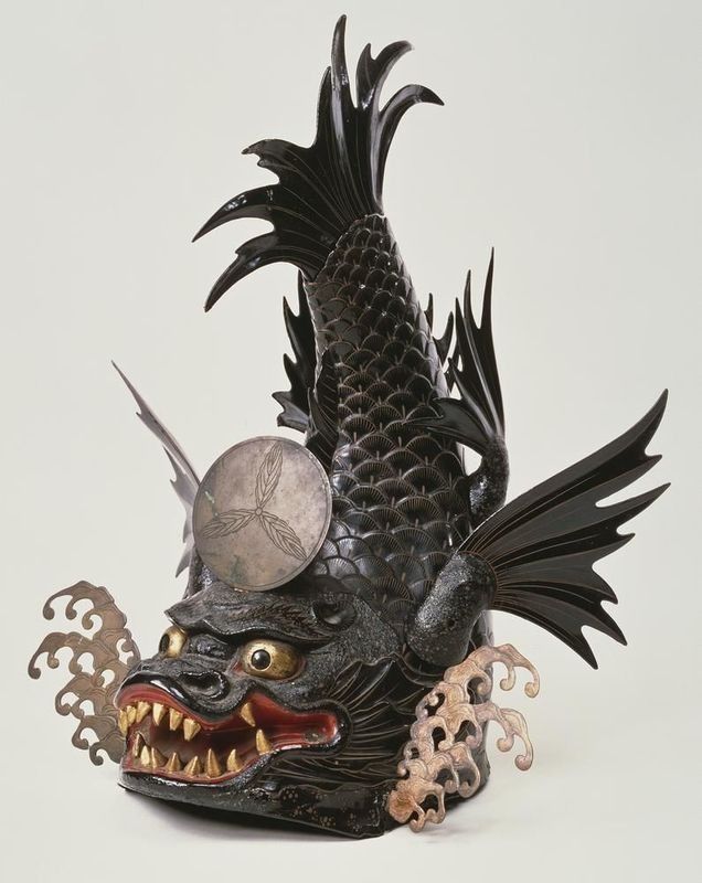 Black lacquered helmet depicting a dragon-fish creature with a silver plate, red mouth, and wavy details.